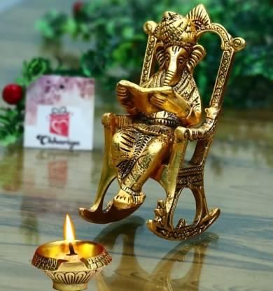 Golden Lord Ganesha Statue Sitting On A Rocking Chair And Reading Ramayan Showpiece - VAYARA